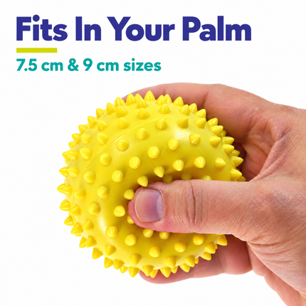 Yellow 9 cm spiky massage ball held in one hand, available in 7.5 cm and 9 cm sizes