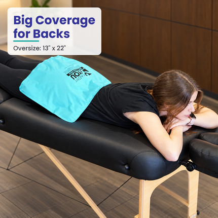 Oversize 13 x 22 in hot/cold pack on the lower back of a person lying on a treatment table