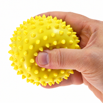 Soft yellow 9 cm spiky massage ball in hand