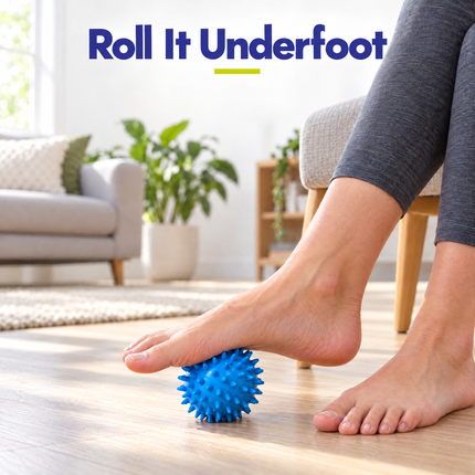 Rolling a blue spiky massage ball under the foot while seated